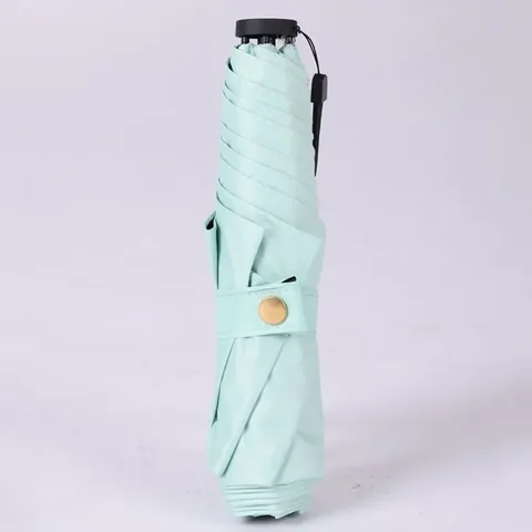 접혀있는 밝은 민트색 펜슬 우산